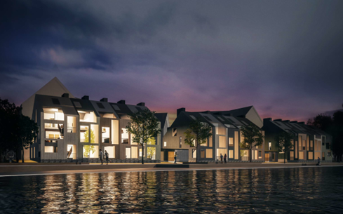 Valaistuja terassitaloja iltavalaistuksessa rantabulevardin varrella.