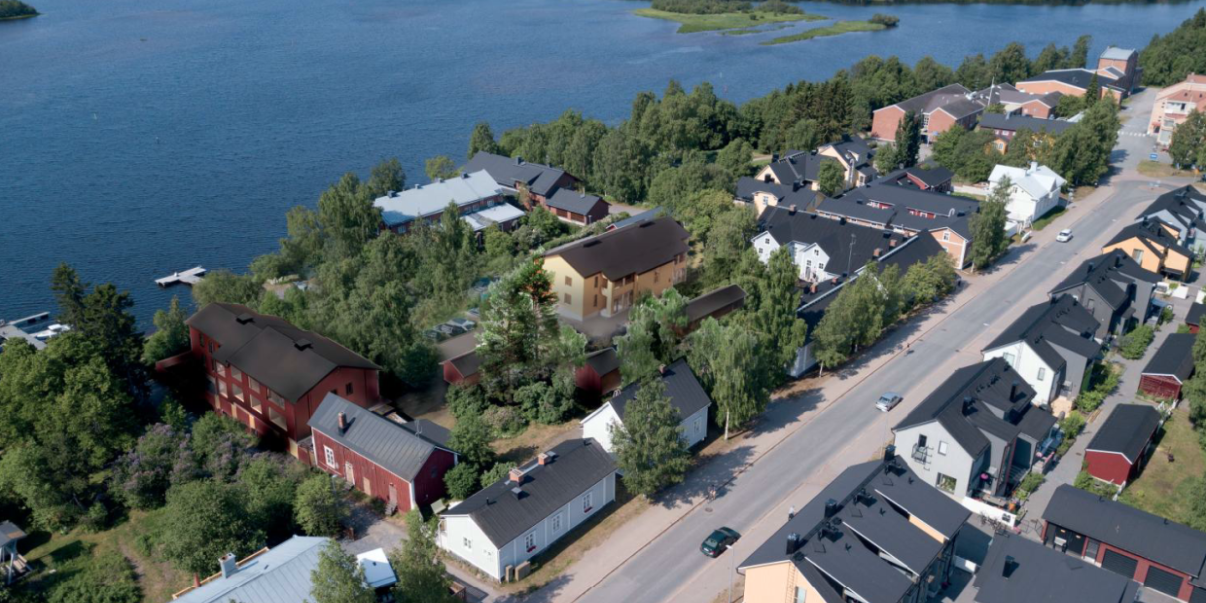 Ilmakuva Pikisaaresta, johon on lisätty piirroksena keltainen ja punainen matala kerrostalo.