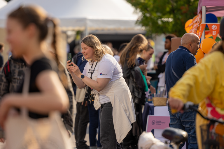 Woman taking a photo with a smartphone