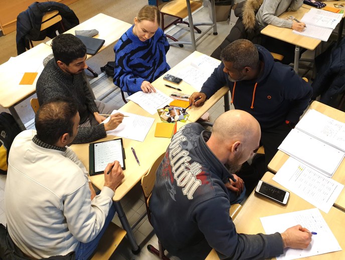 Students doing assignments in a classroom.