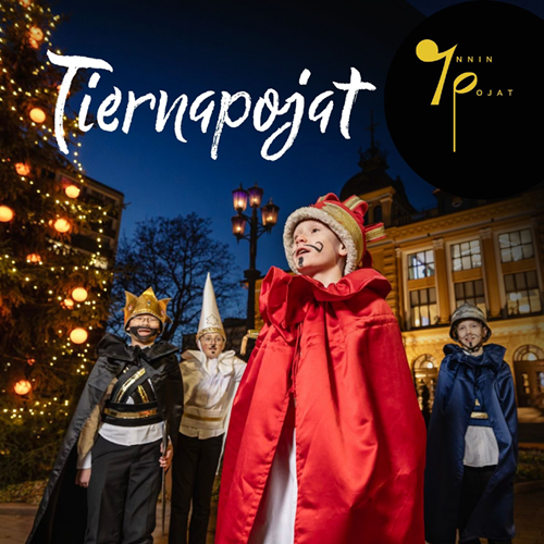 Four children in front of the city hall with Tiernapojat costumes on